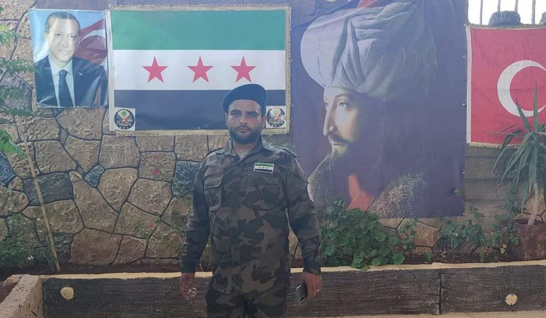 A terrorist photographed next to Erdogan’s photo in Syria