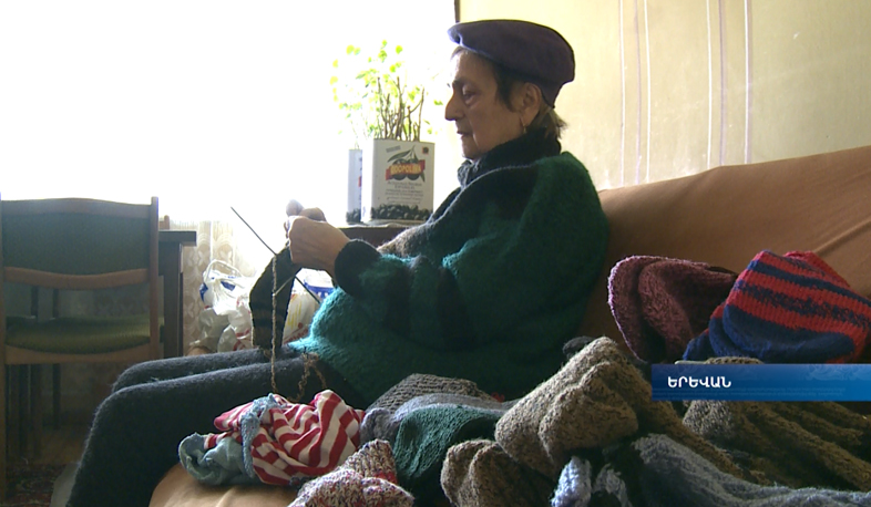 80-year-old Mrs. Janetta knits homemade socks for the army