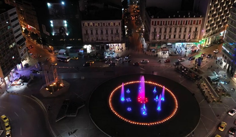 Fountains of central square of Athens lighted with Armenian tricolor