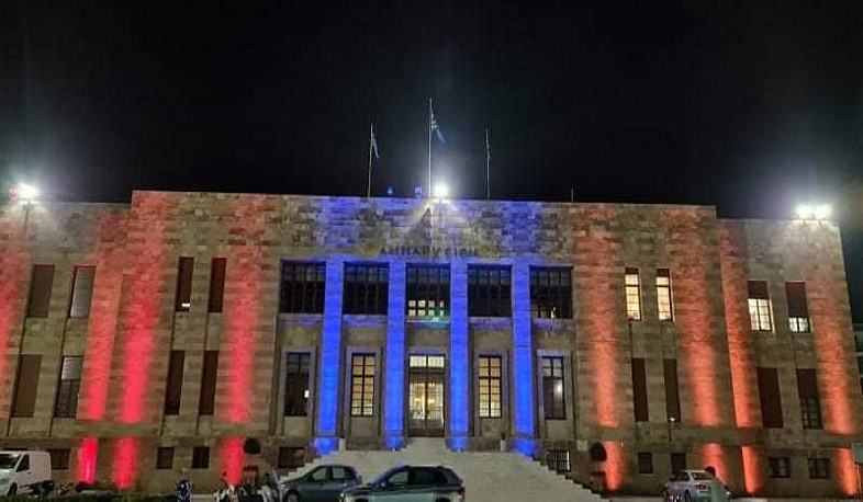 City Hall of Rhodes and fountains of Omonia Square of Athens illuminated Armenian tricolor