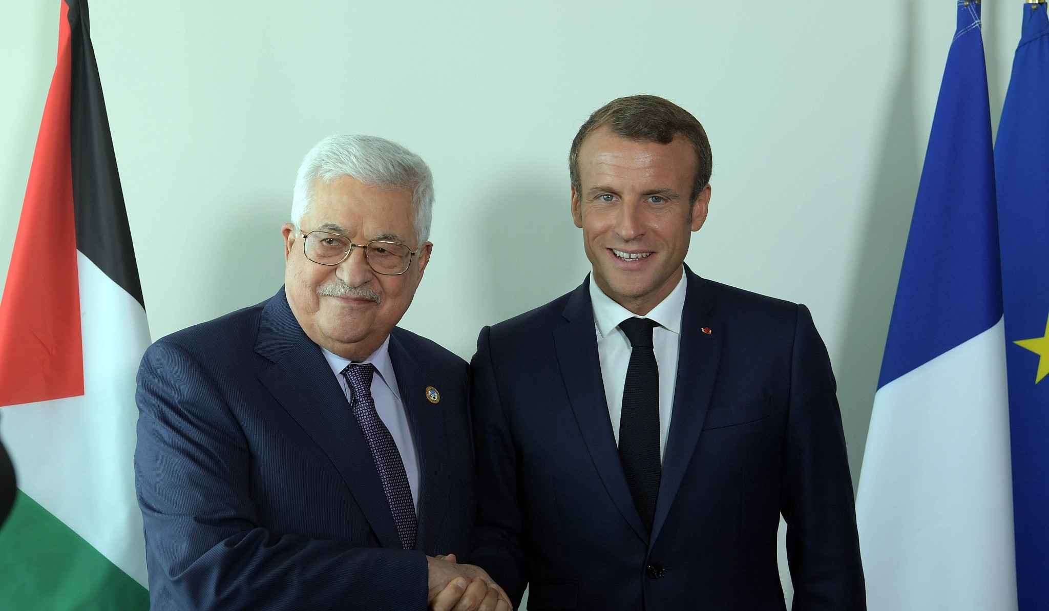 Macron calls for 're-igniting the fire' in Middle East peace talks, as he meets with Abbas