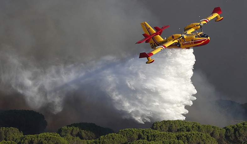 Planes drop water on large wildfire burning in two departments of southern France