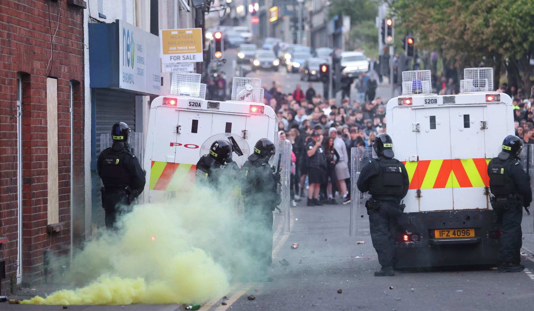 Northern Ireland police in riot gear on second night of anti-migration violence in Belfast